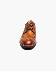 Brown leather brogue shoe on a white background